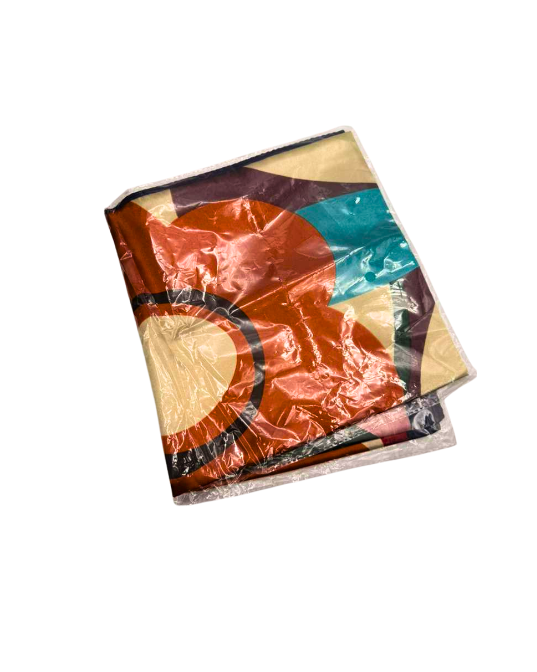 Colorful fabric with geometric patterns with a orange flower hair scarf on a white background